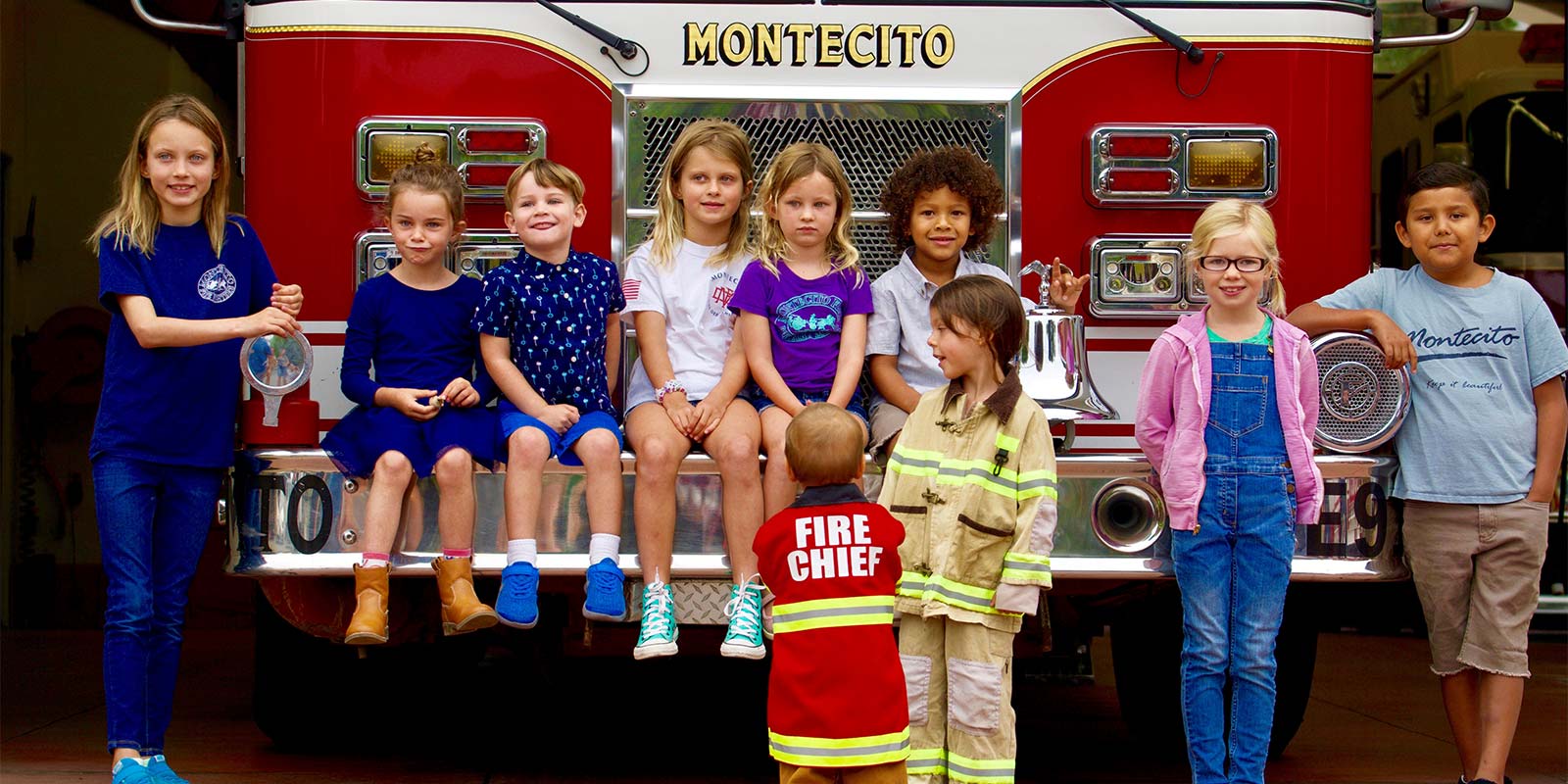 Children sitting before a Montecito fire truck